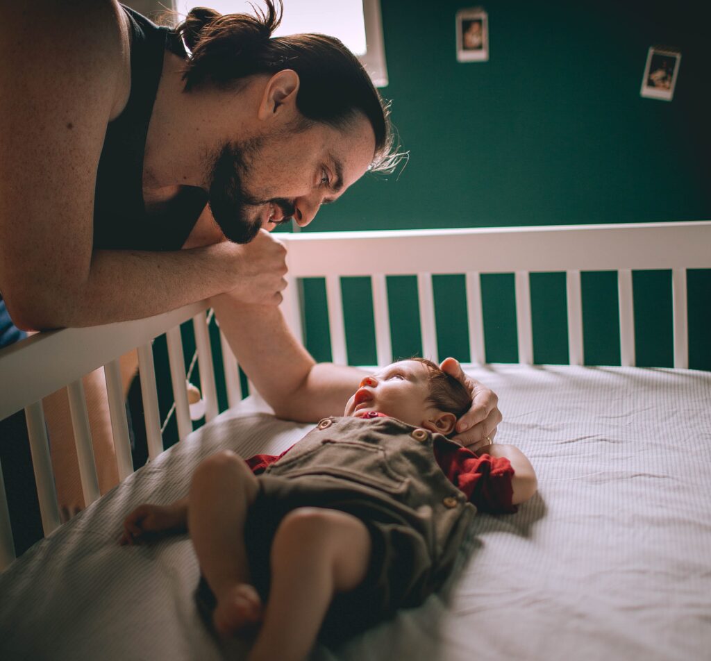 Dad Putting Toddler To Sleep Scaled Aspect Ratio 1707 1588