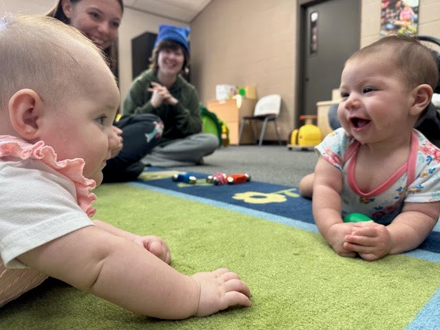 A picture of several babies and their caregivers, engaged in tummy time exercises at the Legacy Parenting Center in Shawnee, OK